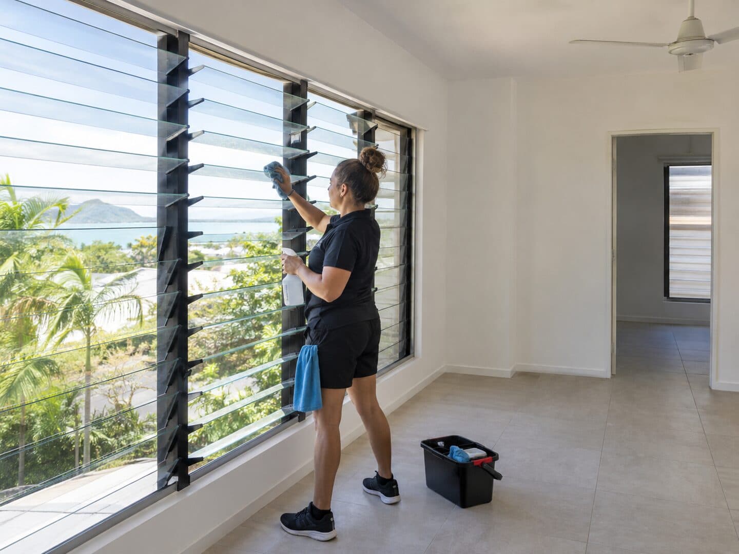 Professional cleaner preparing a rental bathroom for the final inspection