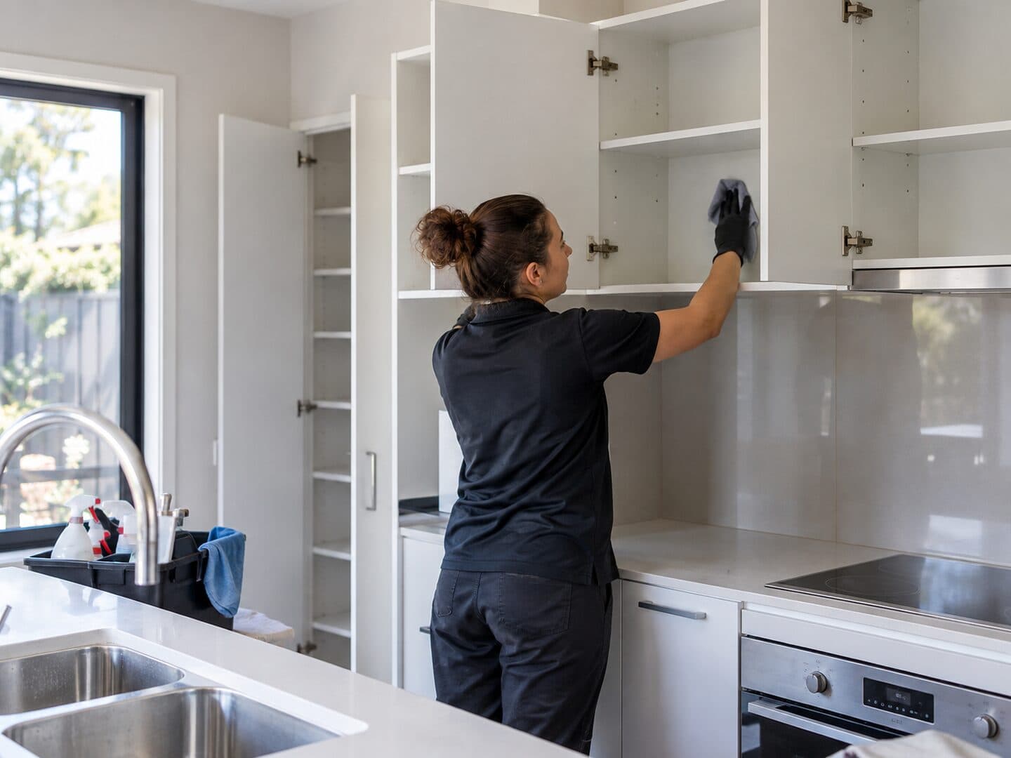Professional cleaner preparing a rental bathroom for the final inspection