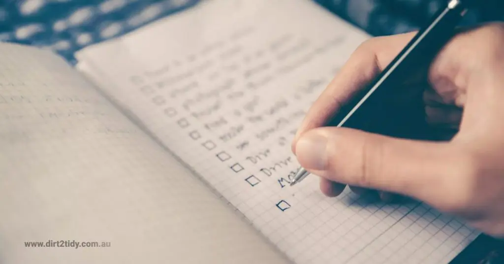 The Ultimate End of Lease Cleaning Checklist in 2025 5 Writing a checklist with a green pen