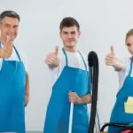 Happy cleaning team giving thumbs up