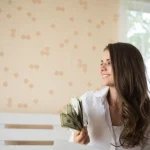 Woman holding money after getting bond refund