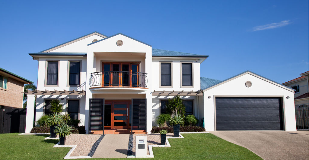 A well-maintained modern double-storey house with a front lawn, garage, and clean facade.