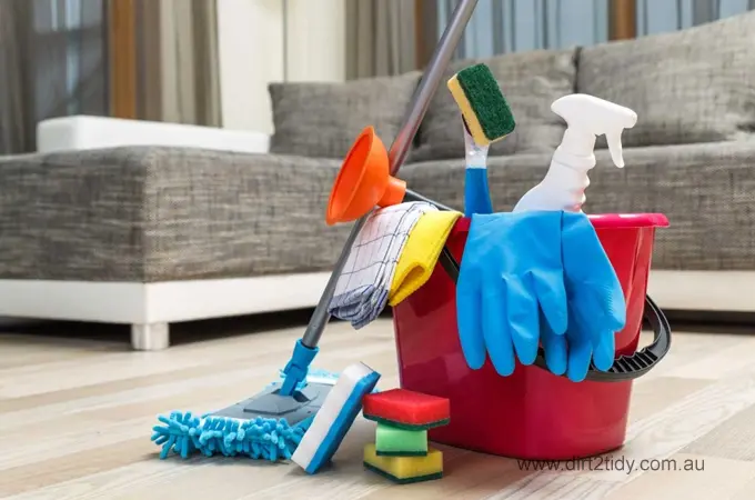 Is there an end of lease cleaning service near me in Sydney? 4 Red cleaning bucket filled with gloves, sponge, spray bottle, mop, and cleaning cloths on a hardwood floor ā showcasing essential home cleaning supplies.