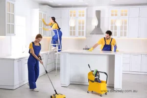 The best end of lease cleaning Botany 2 Professional cleaning team working in a bright white kitchen with modern equipment.