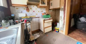 A messy and cluttered kitchen space before professional cleaning.