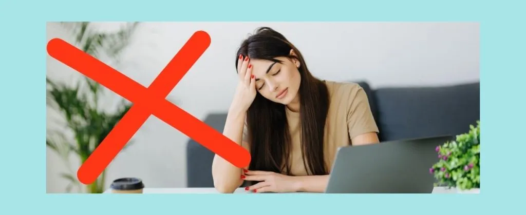 Stressed woman at desk with red cross symbol, showing what to avoid.