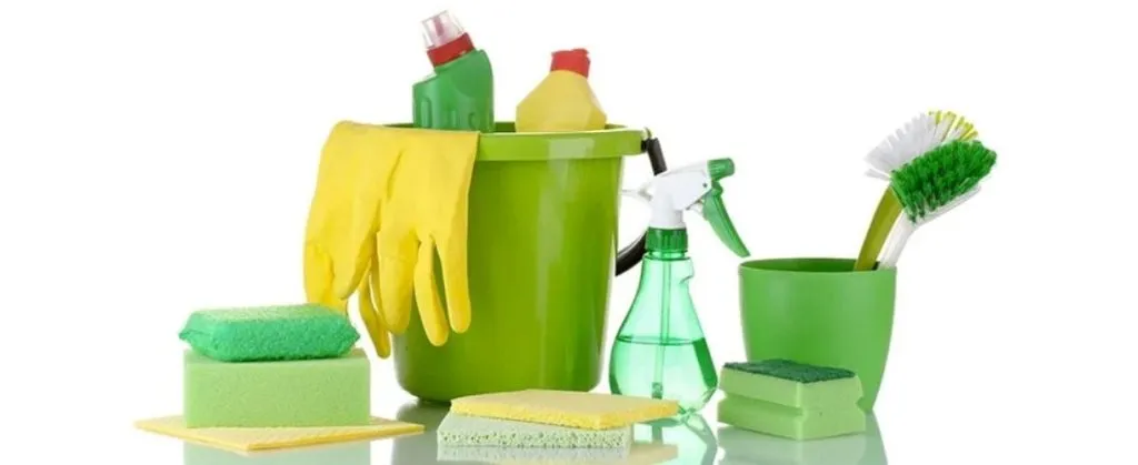How to Ensure Tenant Satisfaction with End-of-Lease Cleaning 4 Set of green cleaning supplies with gloves, sponges, and spray bottles.